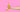A male arm and hand holding a banana on a pink background